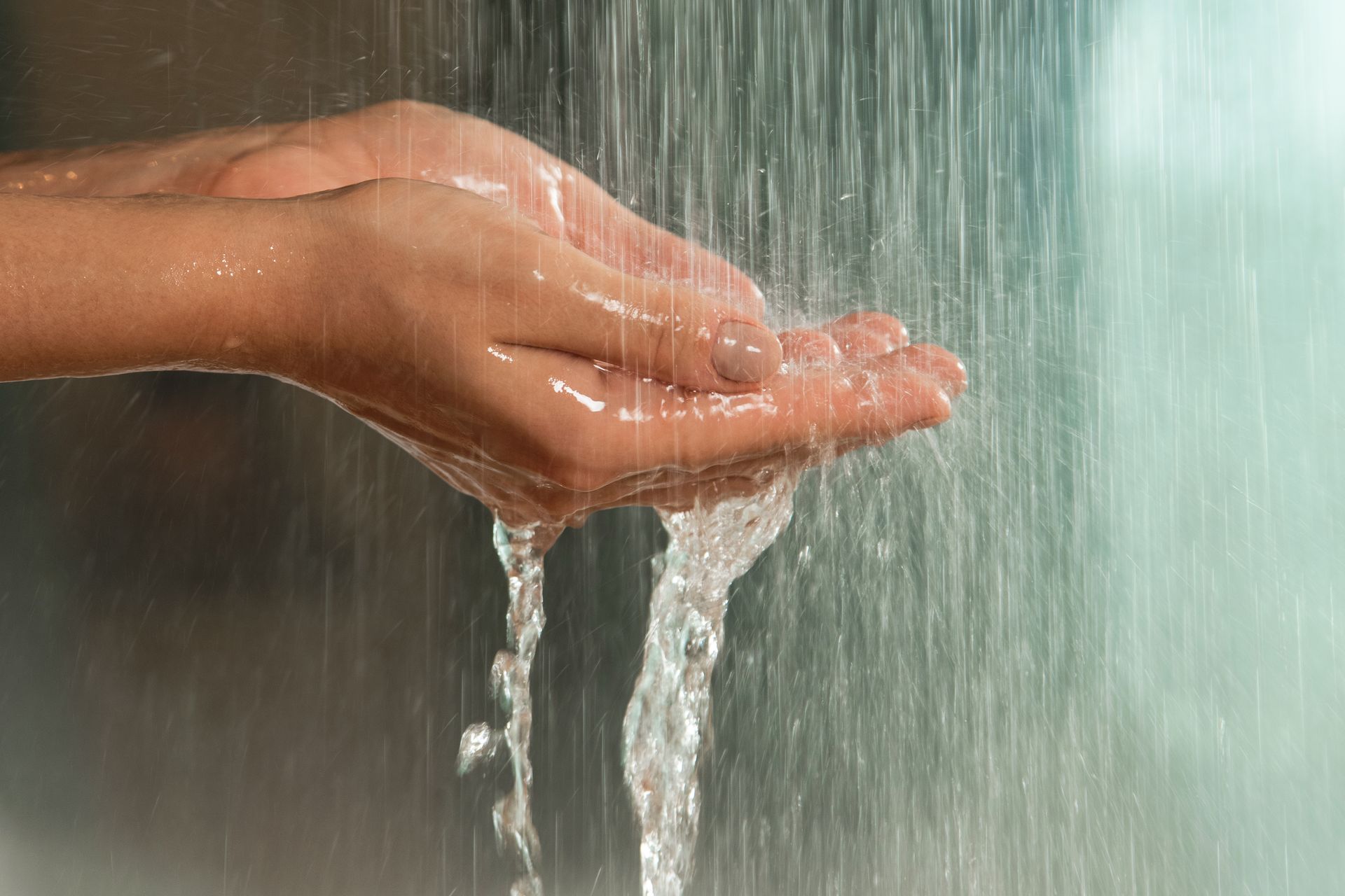 gentle-hands-under-a-stream-of-falling-water-2025-03-11-13-07-03-utc-2880w